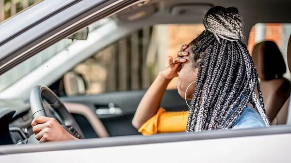 Worried woman driving in car